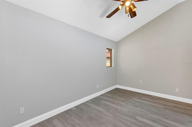 5039 Jamaica Cir Unit 10, Orlando, FL 32808 - unfurnished room featuring a ceiling fan, vaulted ceiling, dark wood-style flooring, and baseboards