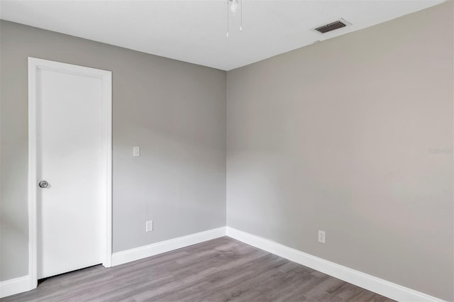 5039 Jamaica Cir Unit 10, Orlando, FL 32808 - spare room with baseboards, wood finished floors, and ceiling fan
