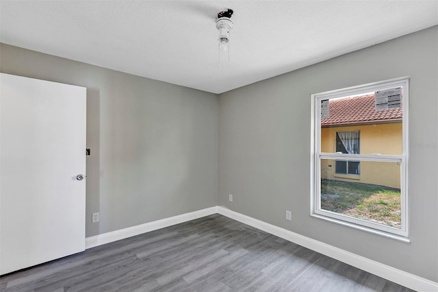 5039 Jamaica Cir Unit 10, Orlando, FL 32808 - empty room featuring plenty of natural light, wood finished floors, and baseboards