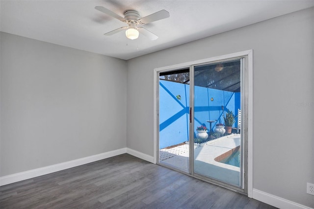 5039 Jamaica Cir Unit 10, Orlando, FL 32808 - unfurnished room featuring baseboards, dark wood-type flooring, and ceiling fan