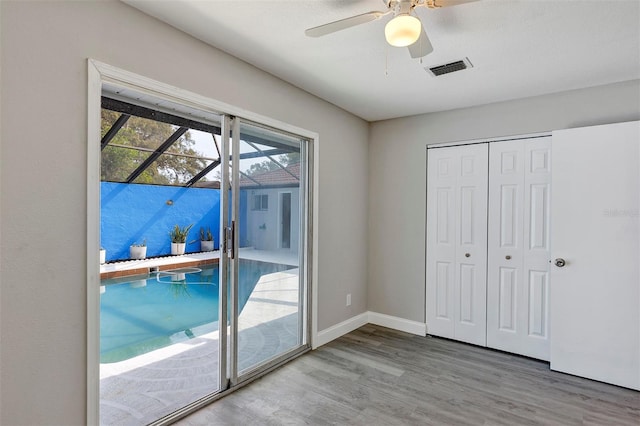 5039 Jamaica Cir Unit 10, Orlando, FL 32808 - doorway to outside featuring wood finished floors, a ceiling fan, and baseboards