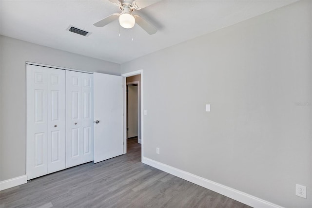 5039 Jamaica Cir Unit 10, Orlando, FL 32808 - unfurnished bedroom with baseboards, wood finished floors, a closet, and ceiling fan