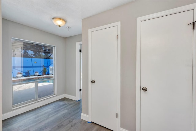 5039 Jamaica Cir Unit 10, Orlando, FL 32808 - entrance foyer with wood finished floors, baseboards, and a textured ceiling