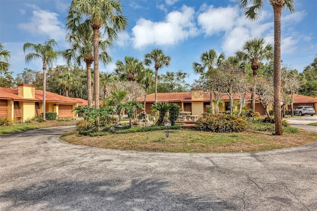 5039 Jamaica Cir Unit 10, Orlando, FL 32808 - view of front facade featuring curved driveway and stucco siding