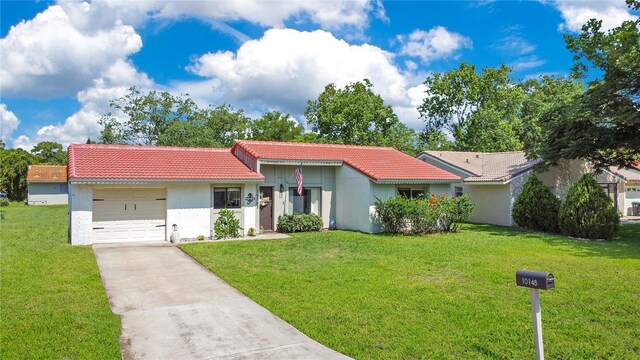 10148 Eventide Ct, Orlando, FL 32821 - view of front of home with a tile roof, driveway, and stucco siding