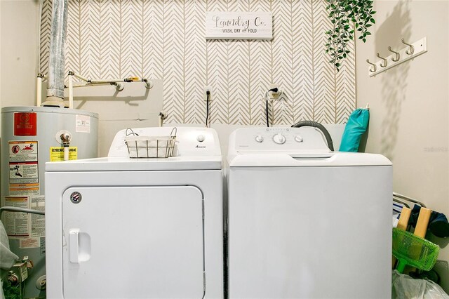 10148 Eventide Ct, Orlando, FL 32821 - laundry room with water heater and independent washer and dryer