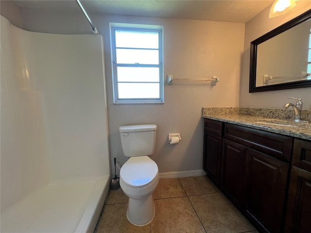 51 Windtree Ln Unit 101, Winter Garden, FL 34787 - full bathroom featuring a shower, toilet, vanity, tile patterned flooring, and baseboards