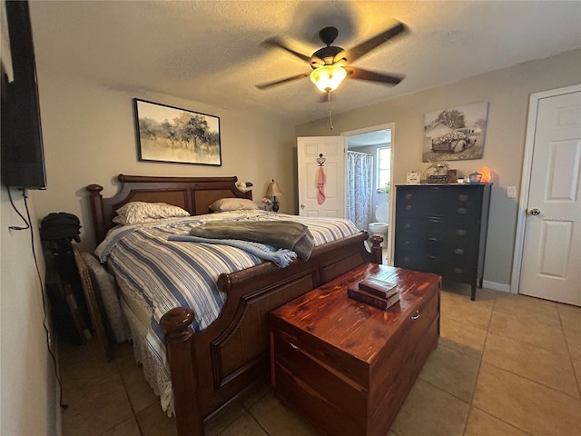 51 Windtree Ln Unit 101, Winter Garden, FL 34787 - bedroom featuring light tile patterned flooring, a ceiling fan, ensuite bath, and a textured ceiling