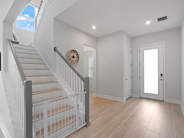 6875 Bridgman St, Orlando, FL 32827 - entrance foyer with light wood-type flooring, recessed lighting, baseboards, and stairs