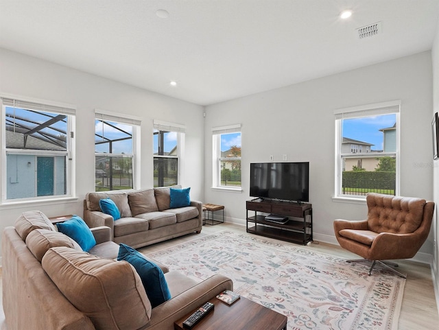 6875 Bridgman St, Orlando, FL 32827 - living room with light wood-style flooring, healthy amount of natural light, recessed lighting, and baseboards