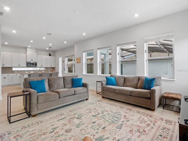 6875 Bridgman St, Orlando, FL 32827 - living area with light wood-style flooring and recessed lighting