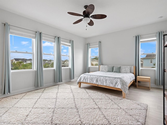 6875 Bridgman St, Orlando, FL 32827 - bedroom with wood finished floors, ceiling fan, and baseboards