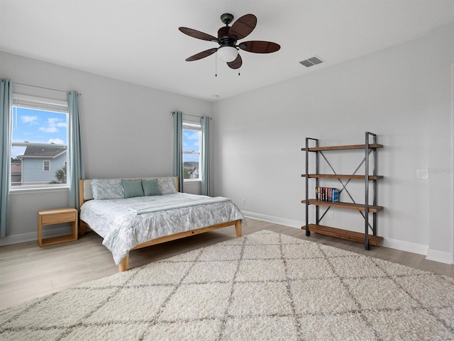 6875 Bridgman St, Orlando, FL 32827 - bedroom with wood finished floors, baseboards, and ceiling fan