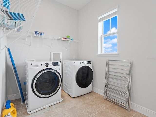 6875 Bridgman St, Orlando, FL 32827 - laundry area featuring washer and clothes dryer, baseboards, and light tile patterned flooring