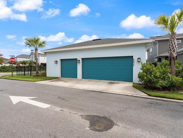 6875 Bridgman St, Orlando, FL 32827 - garage featuring driveway and fence