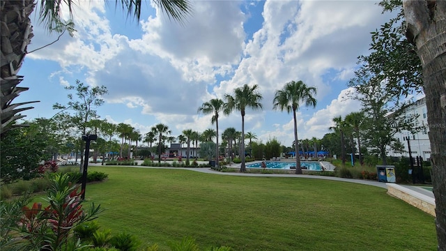 6875 Bridgman St, Orlando, FL 32827 - view of property's community with a lawn and a swimming pool