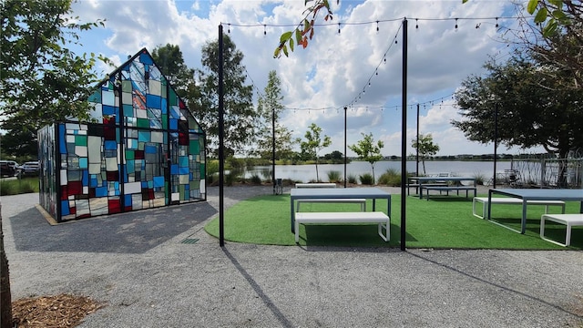 6875 Bridgman St, Orlando, FL 32827 - view of home's community featuring a water view and a lawn
