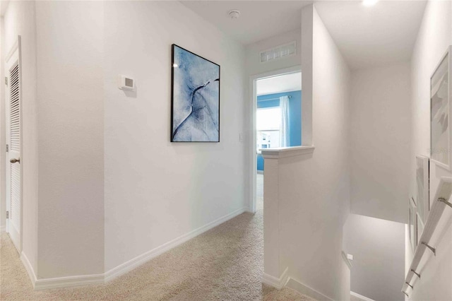 1302 Isleta Loop, Kissimmee, FL 34741 - corridor featuring carpet floors, baseboards, and an upstairs landing