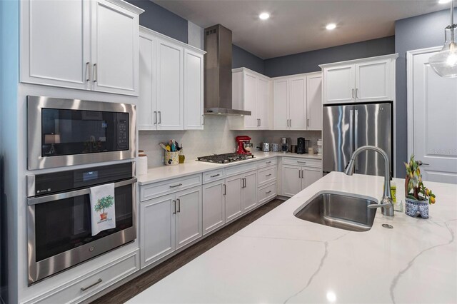 1212 Civitas Way, Winter Garden, FL 34787 - kitchen with stainless steel appliances, wall chimney range hood, a sink, white cabinetry, and recessed lighting