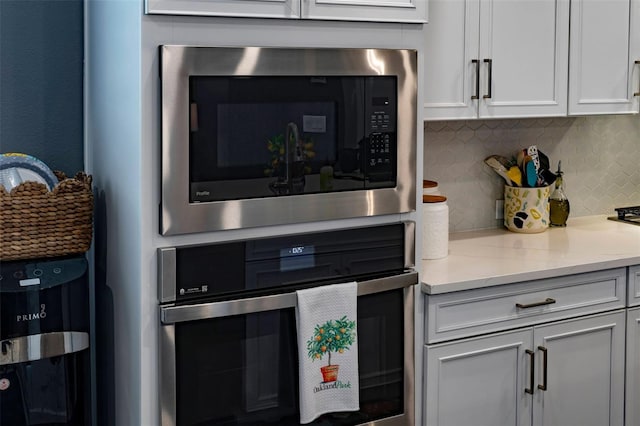 1212 Civitas Way, Winter Garden, FL 34787 - kitchen featuring stainless steel appliances, tasteful backsplash, light stone counters, and white cabinets