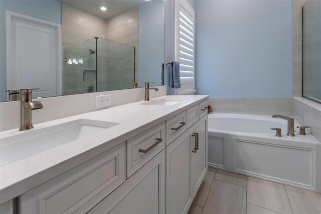 1212 Civitas Way, Winter Garden, FL 34787 - bathroom featuring a bath, a shower stall, tile patterned flooring, double vanity, and recessed lighting