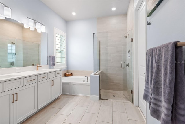 1212 Civitas Way, Winter Garden, FL 34787 - bathroom featuring a shower stall, double vanity, a garden tub, tile patterned floors, and recessed lighting