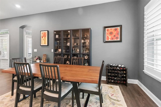 1212 Civitas Way, Winter Garden, FL 34787 - dining area featuring arched walkways, wood finished floors, and baseboards
