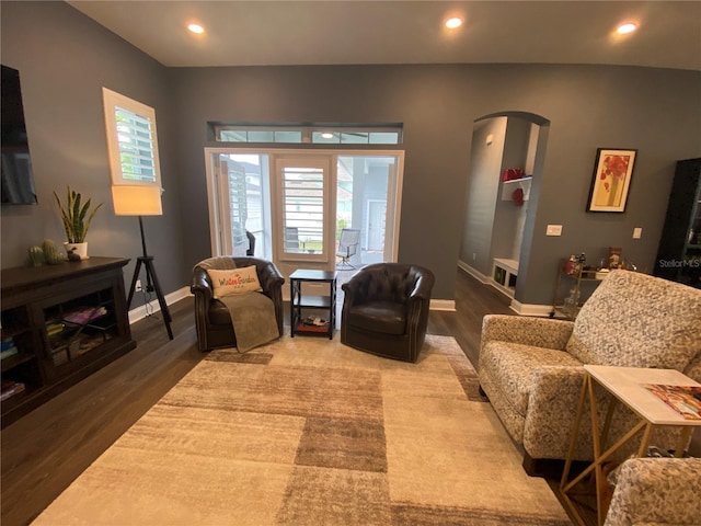 1212 Civitas Way, Winter Garden, FL 34787 - living area with arched walkways, wood finished floors, healthy amount of natural light, and recessed lighting