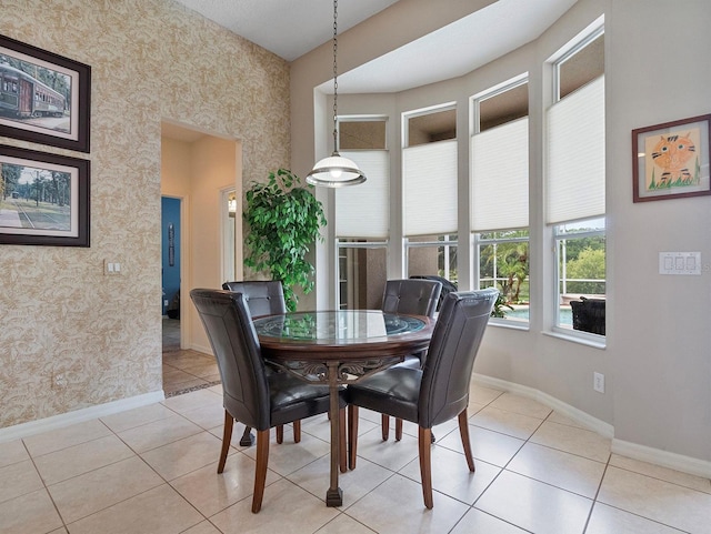 3840 Caledonia Ave, Apopka, FL 32712 - dining area with wallpapered walls, baseboards, and light tile patterned floors