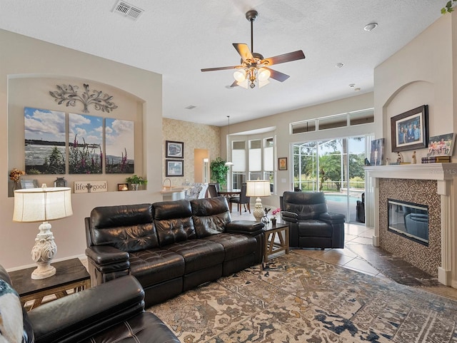 3840 Caledonia Ave, Apopka, FL 32712 - living area featuring ceiling fan, a high end fireplace, and a textured ceiling