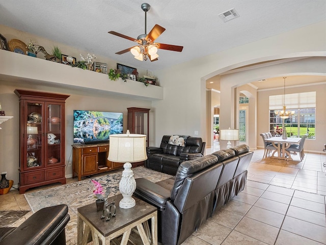 3840 Caledonia Ave, Apopka, FL 32712 - living area featuring arched walkways, a chandelier, ceiling fan, light tile patterned flooring, and a textured ceiling