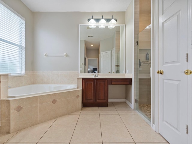 3840 Caledonia Ave, Apopka, FL 32712 - full bath featuring tile patterned floors, a bath, a stall shower, and healthy amount of natural light