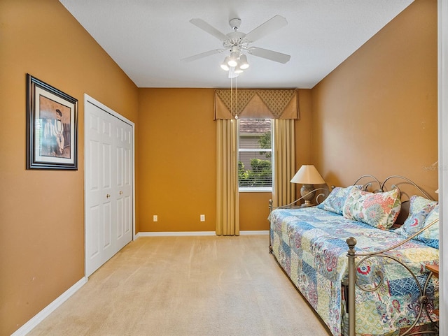 3840 Caledonia Ave, Apopka, FL 32712 - bedroom featuring baseboards, light carpet, a closet, and a ceiling fan
