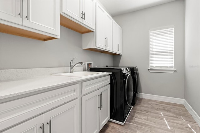 1272 Patterson Ter, Lake Mary, FL 32746 - washroom featuring washing machine and dryer, cabinet space, baseboards, and light wood-type flooring