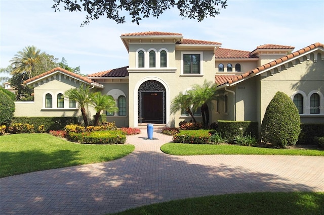11013 Ullswater Ln, Windermere, FL 34786 - mediterranean / spanish-style home featuring a tile roof, stucco siding, and a front yard