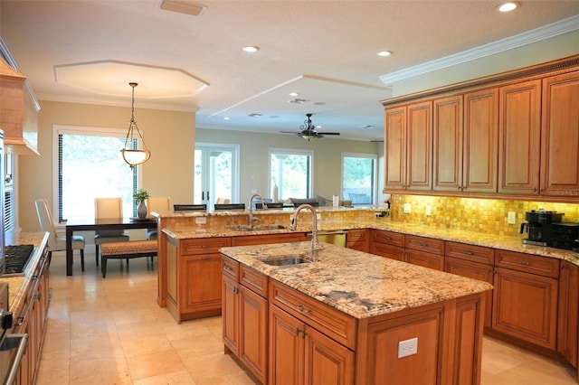 11013 Ullswater Ln, Windermere, FL 34786 - kitchen with a sink, brown cabinetry, a peninsula, and recessed lighting