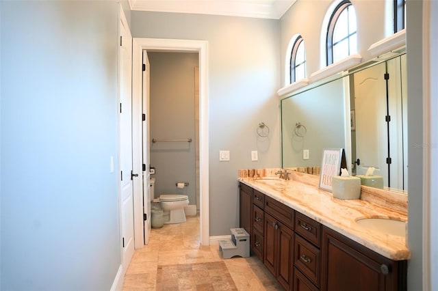 11013 Ullswater Ln, Windermere, FL 34786 - bathroom with toilet, double vanity, baseboards, and ornamental molding