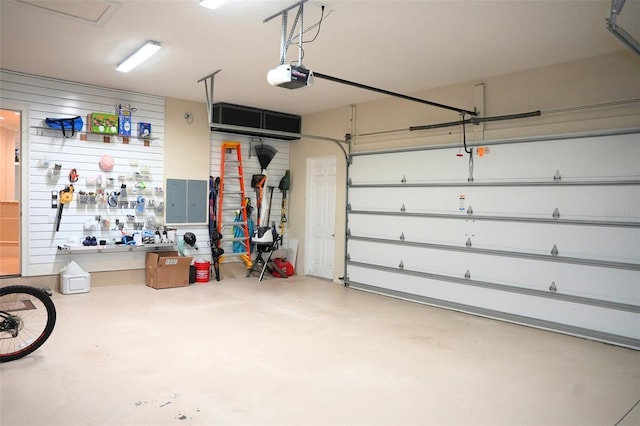 11013 Ullswater Ln, Windermere, FL 34786 - garage featuring a garage door opener and a workshop area