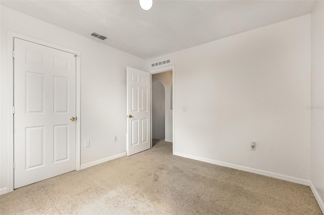 unfurnished bedroom featuring carpet floors and baseboards