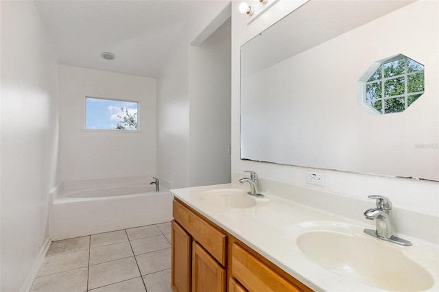 bathroom with a bath, double vanity, tile patterned floors, and baseboards