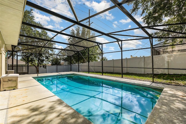 view of pool featuring a patio, glass enclosure, and fence