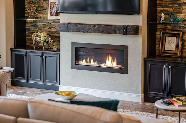 11755 Waterstone Loop Dr, Windermere, FL 34786 - living room featuring a glass covered fireplace and baseboards