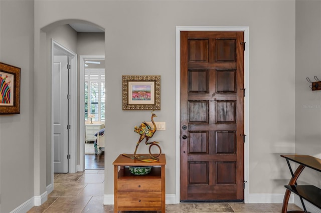 11755 Waterstone Loop Dr, Windermere, FL 34786 - entrance foyer featuring arched walkways, baseboards, and tile patterned floors