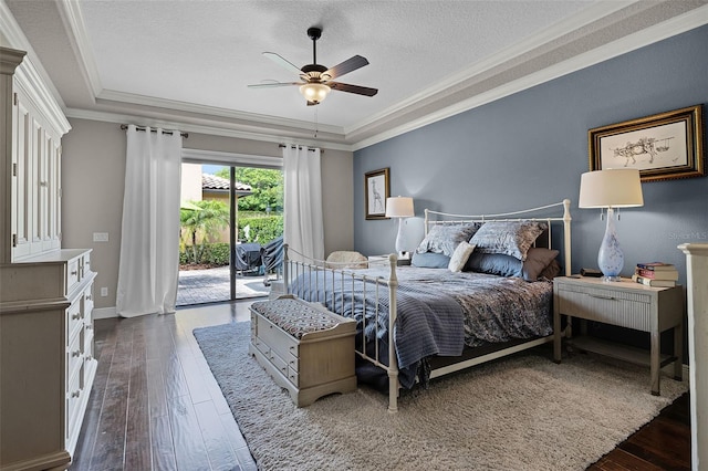 11755 Waterstone Loop Dr, Windermere, FL 34786 - bedroom with crown molding, access to outside, a tray ceiling, dark wood-style flooring, and a textured ceiling