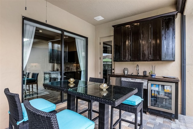 11755 Waterstone Loop Dr, Windermere, FL 34786 - bar featuring beverage cooler, a sink, fridge, and light stone finish floors