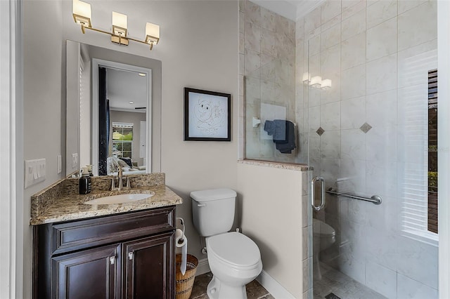 11755 Waterstone Loop Dr, Windermere, FL 34786 - bathroom featuring a shower stall, toilet, baseboards, vanity, and ensuite bath