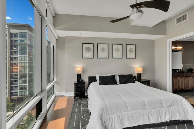 101 S Eola Dr Unit 810, Orlando, FL 32801 - bedroom featuring wood finished floors, multiple windows, and baseboards