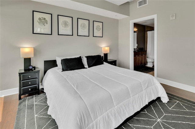 101 S Eola Dr Unit 810, Orlando, FL 32801 - bedroom featuring hardwood / wood-style flooring, baseboards, and connected bathroom