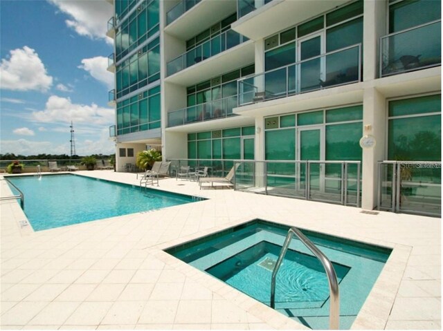 101 S Eola Dr Unit 810, Orlando, FL 32801 - community pool with a hot tub and a patio area