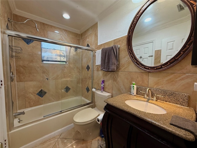 full bathroom featuring ornamental molding, tile walls, shower / bath combination with glass door, toilet, and vanity